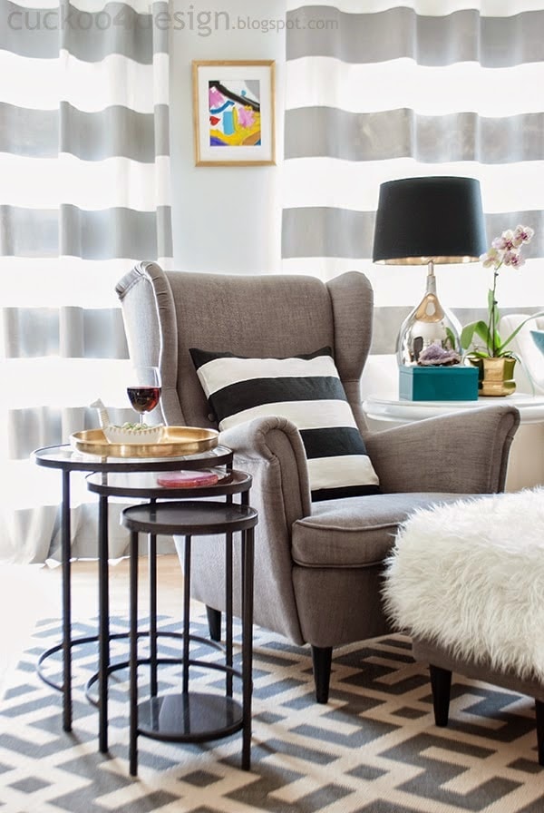 horizontal striped curtains behind gray Ikea living room chair