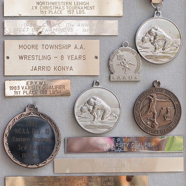 awards plaques and metals arranged in a collage