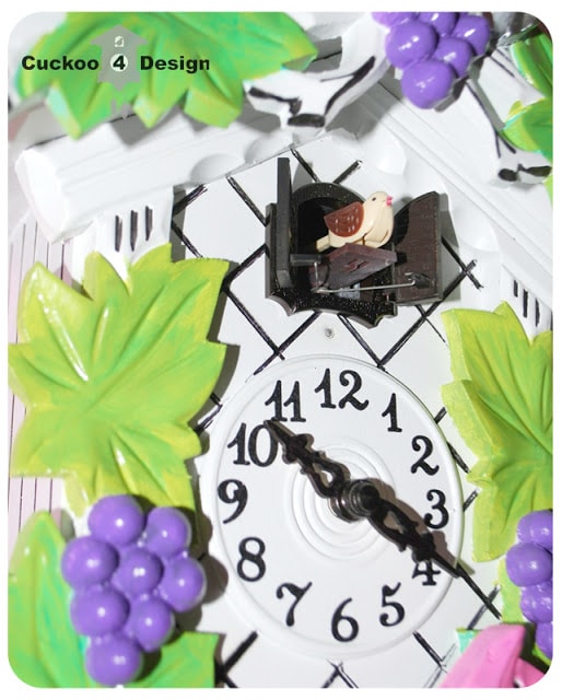 lime green, silver, pink, purple, black and white cuckoo clock