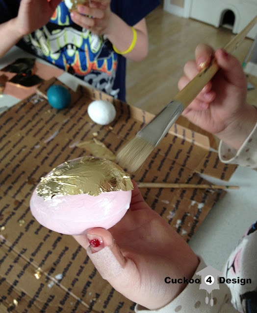 kids painting paper mache eggs with craft paint