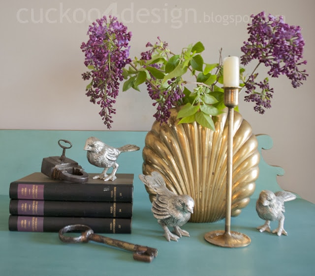 brass accents with books and silver