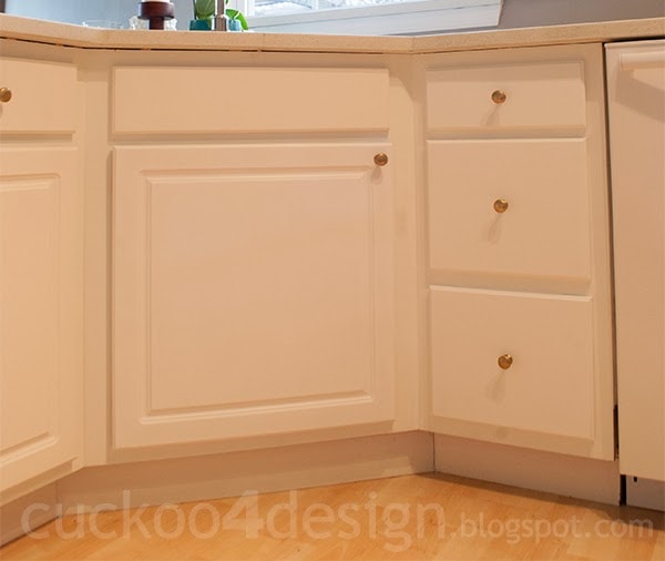 close-up of newly peeled and painted cabinet doors in kitchen