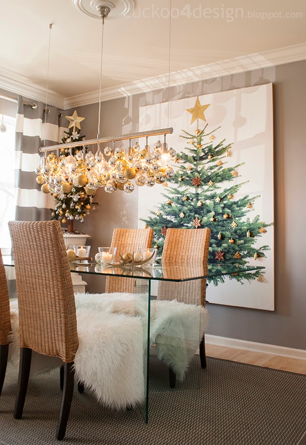linear chandelier over dining table covered in cold and silver Christmas ball ornaments