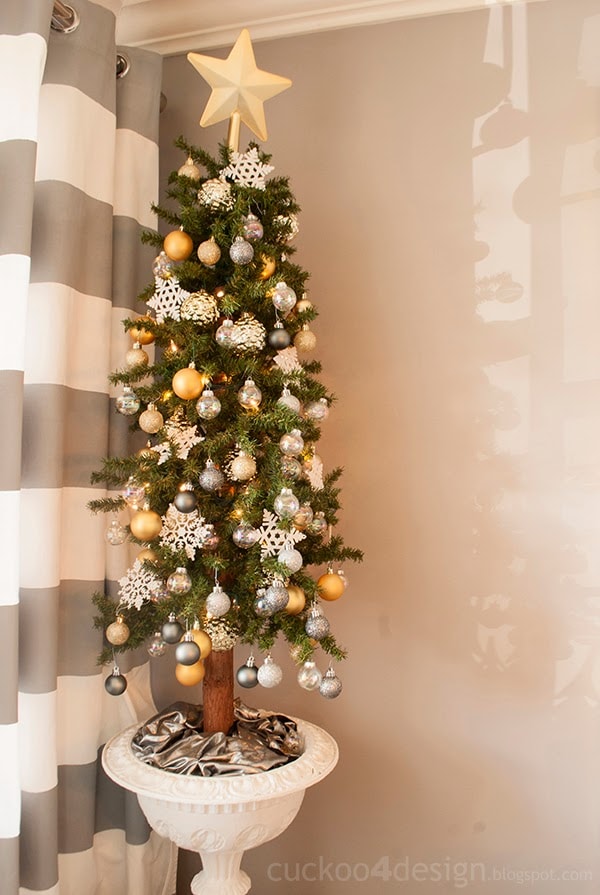 corner Christmas tree in dining room with white, silver and gold ornaments