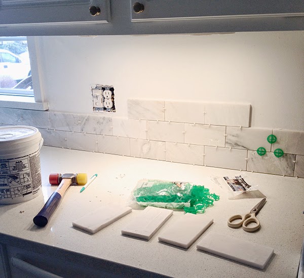 moving along marble subway tile from window to stove