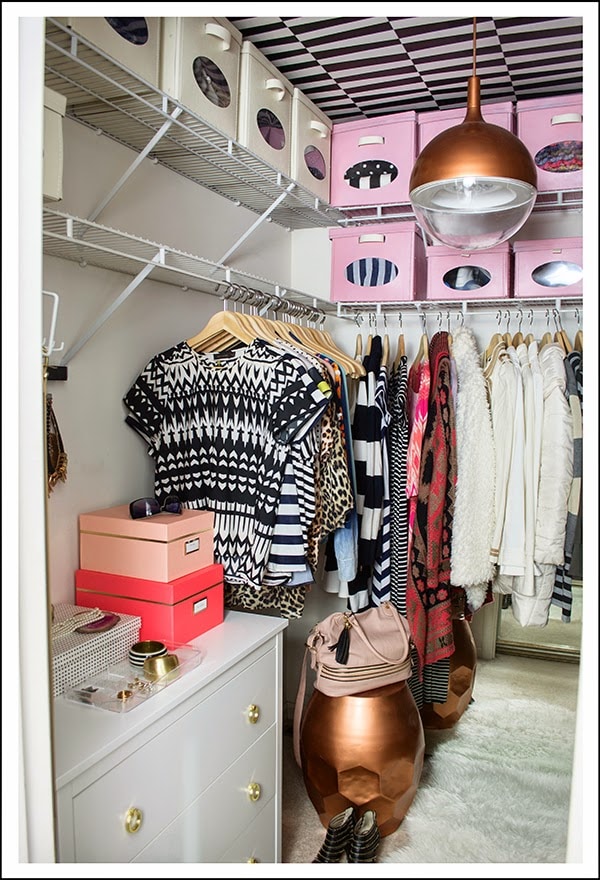 pink and white storage boxes in finished walk-in closet before