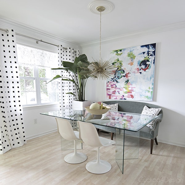 modern eclectic dining room with colorful abstract art and brass urchin chandelier