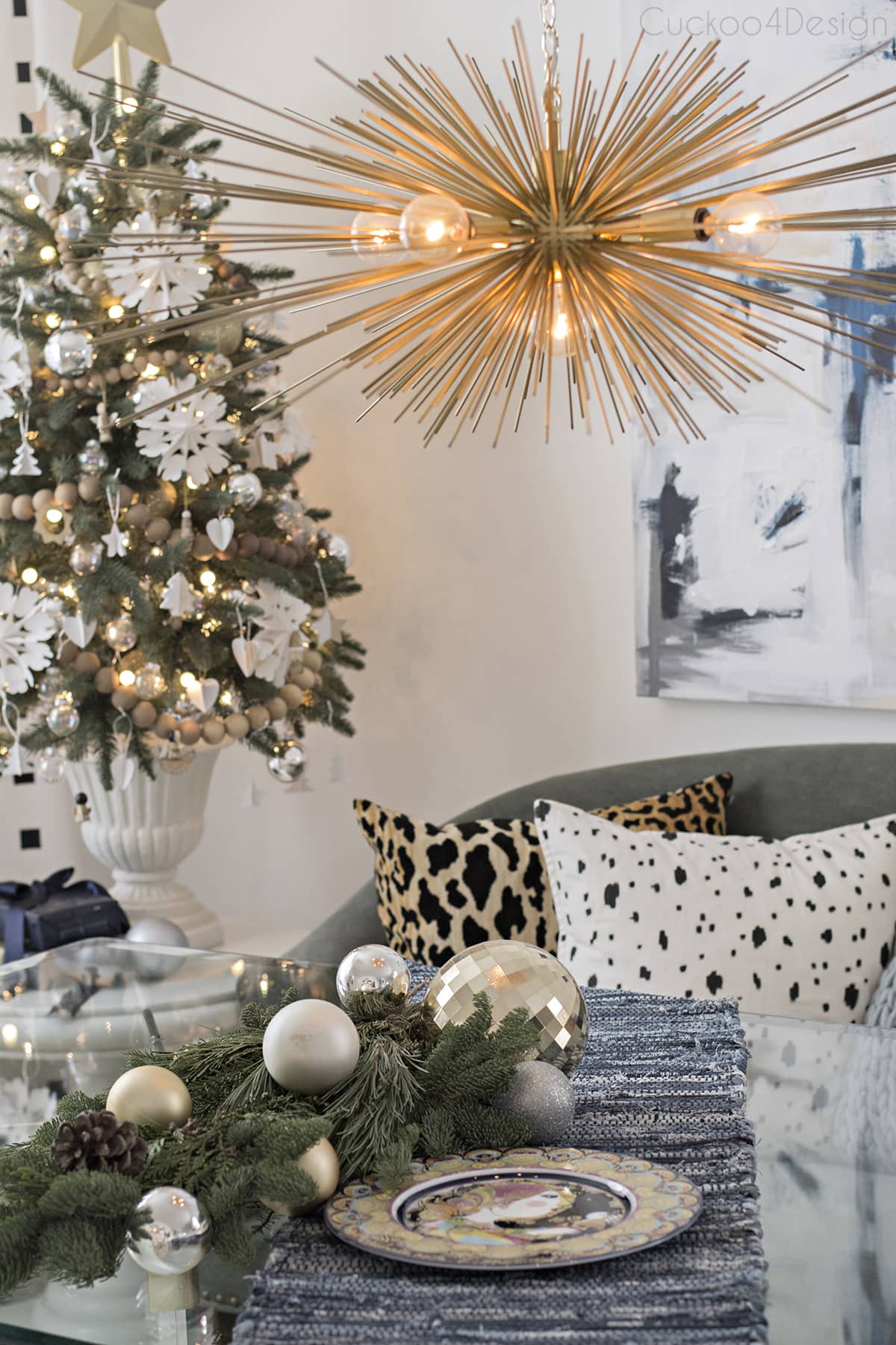 eclectic Christmas dining room with vintage glass table, urchin chandelier and abstract art