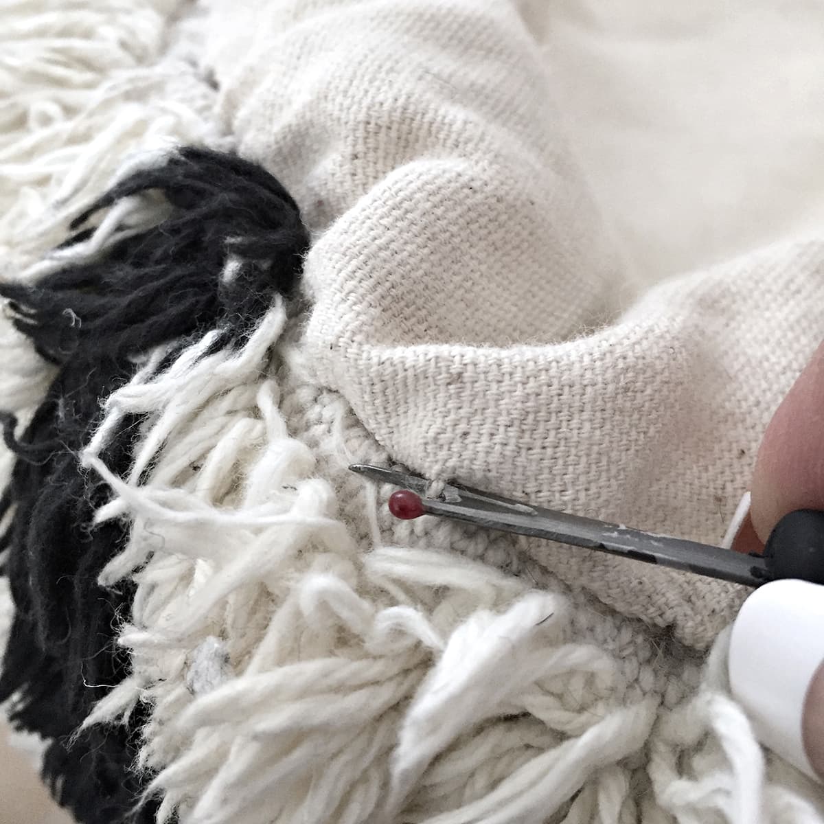 using a seam ripper to open the pouf