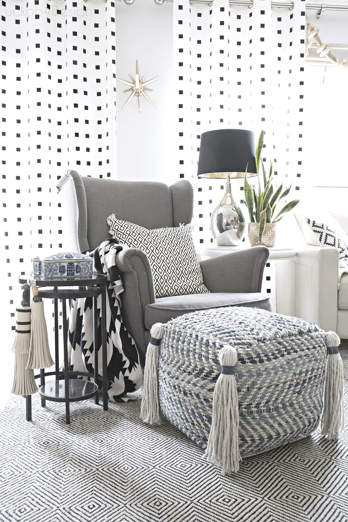 gray Ikea chair with tassel ottoman
