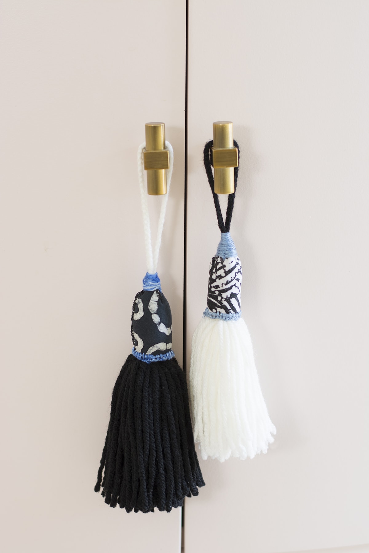 finished colorful yarn tassels hanging on dresser handle