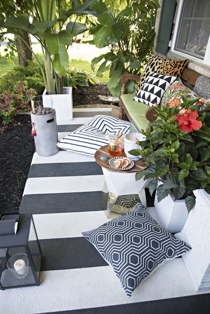 black and white striped porch with tropical colorful accents