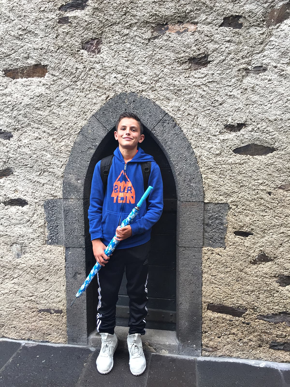 boy standing in small door frame of Eltz castle