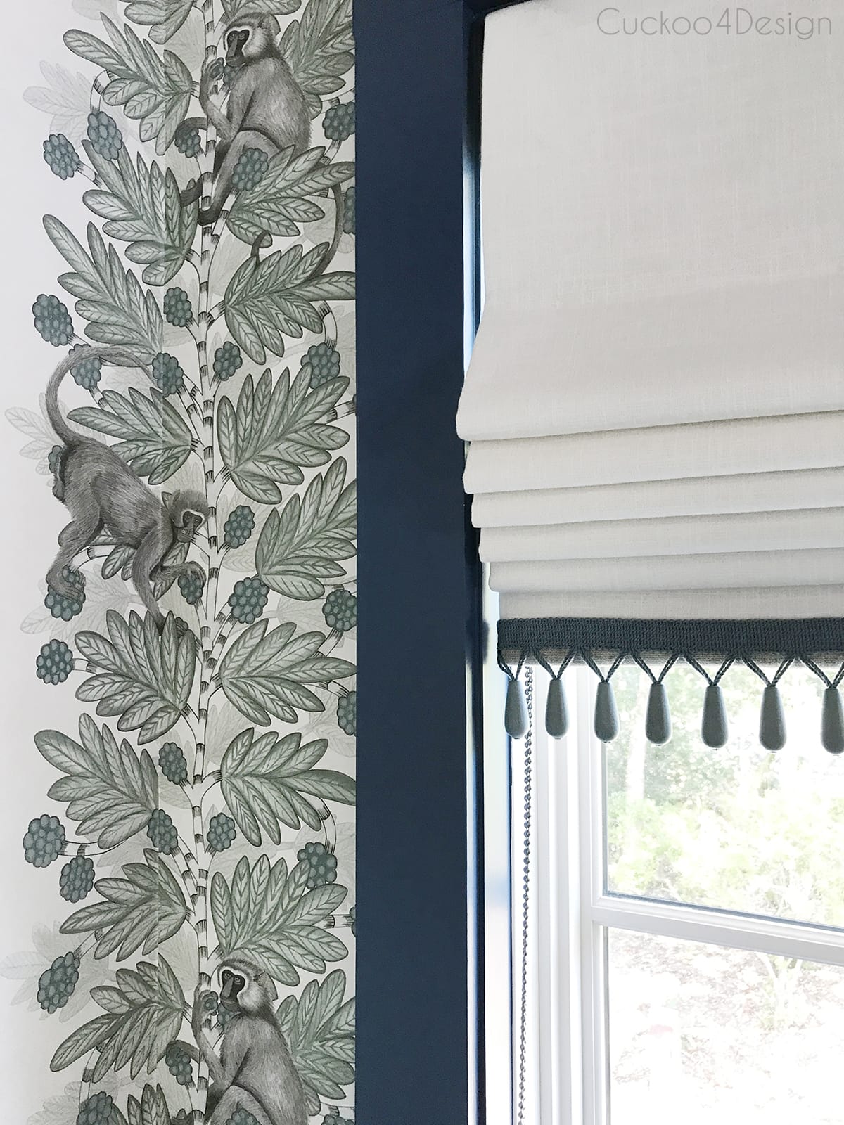 Lee Jofa at Cole & Son wallpaper with blue window trim and roman shades