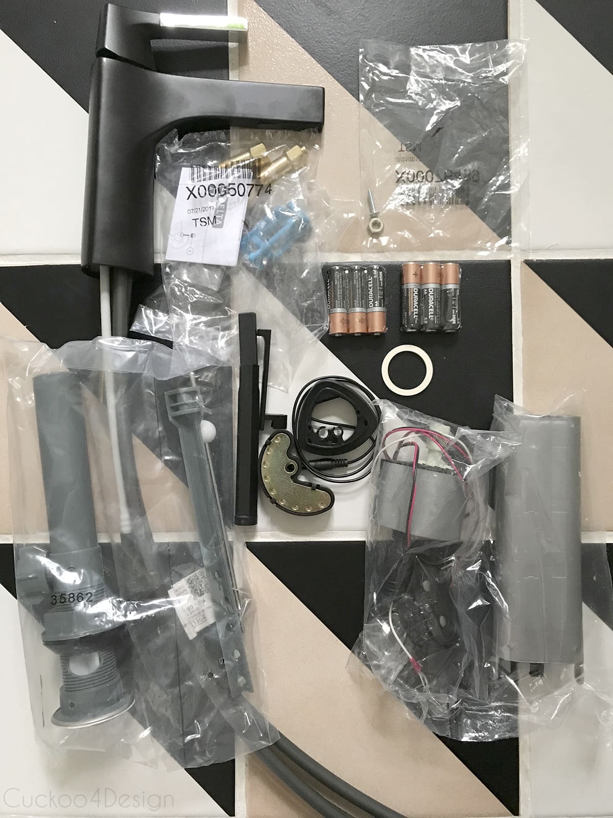 supplies and materials laying on the floor to install a Delta Faucet 574T-CS-DST Zura Single Handle Centerset Bathroom Faucet with Touch2O.xt Technology under an Ikea Godmorgon floating vanity