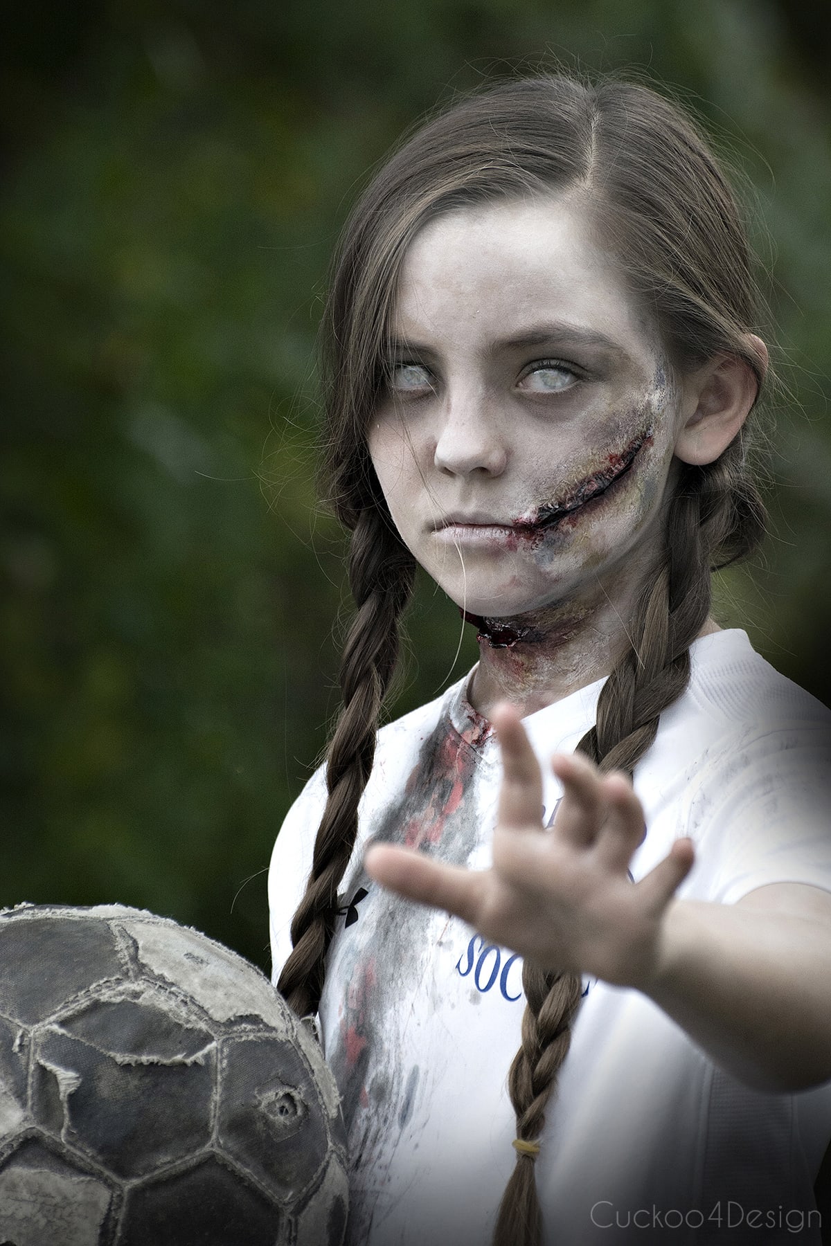soccer zombie girl with bloddy DIY zombie makeup wounds and contacts