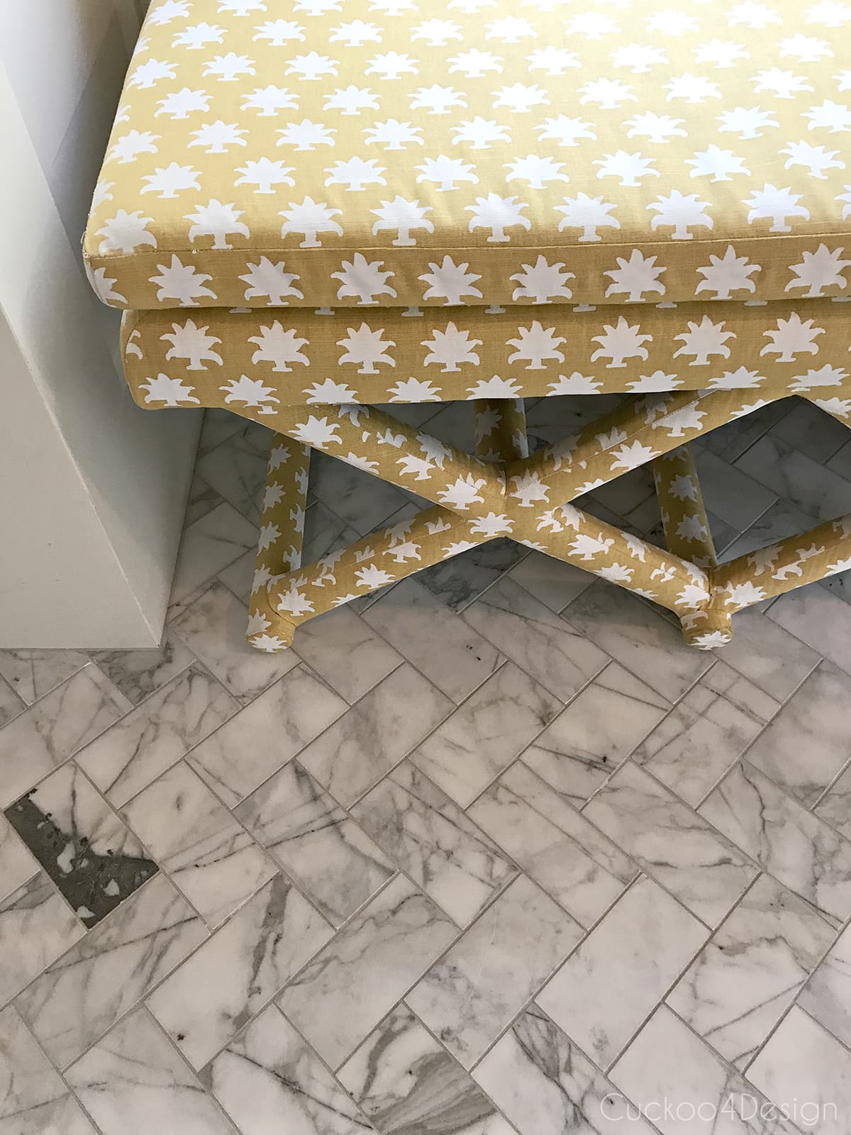 x-bench upholstered with Mally Skok Flora Too Custurd fabric in marble master bathroom