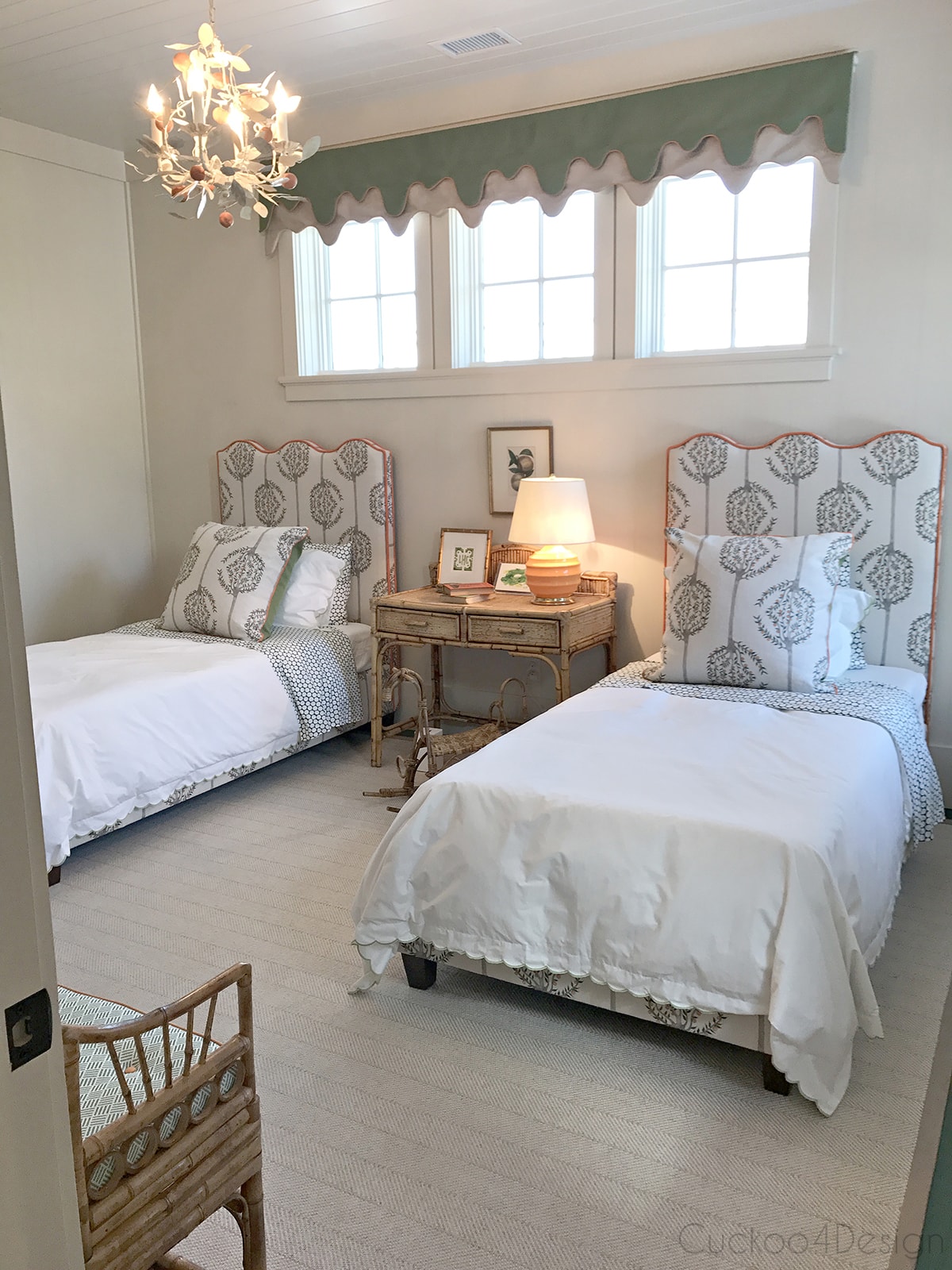 kids bedroom with upholstered headboard, orange trim and vintage wicker furniture