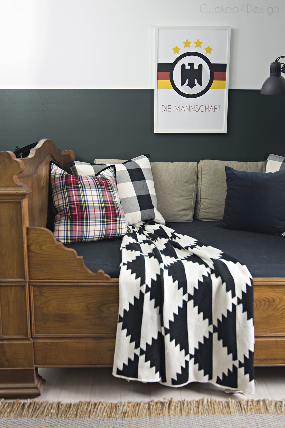butterscotch leather butterfly chair in sophisticated boys bedroom with dark green walls, mixed plaids and soccer memorabilia 
