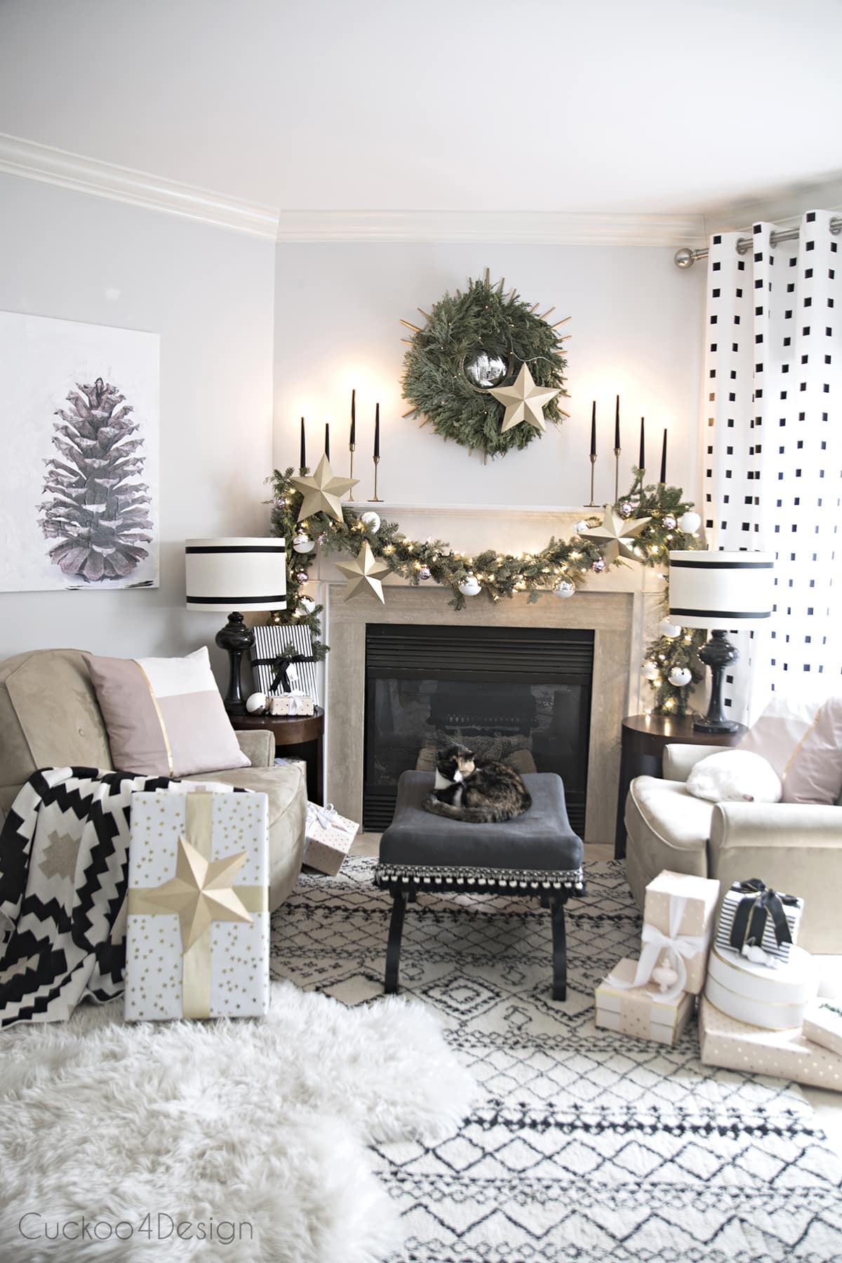 black and white fireplace area with real garland and wreath | pinecone art | cozy shag rugs and blush and metallic accents