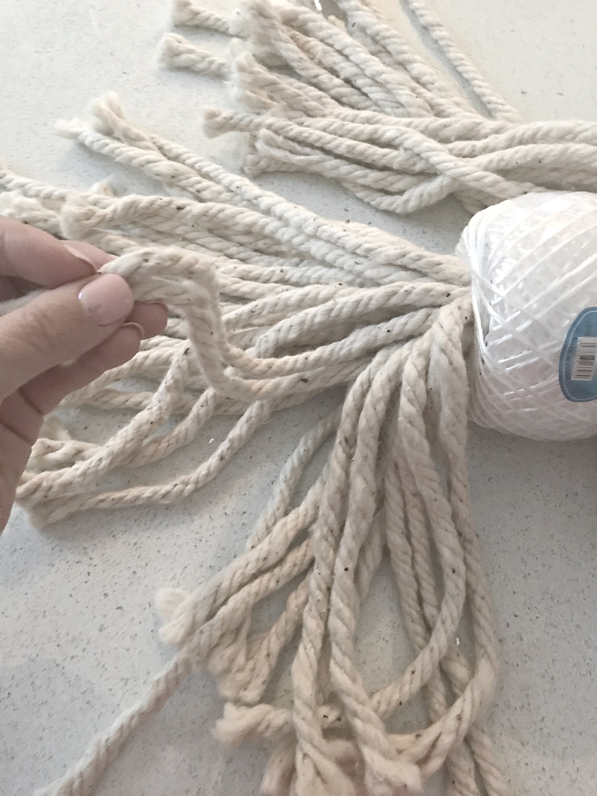 unthreading the mop head yarn to give it more volume 