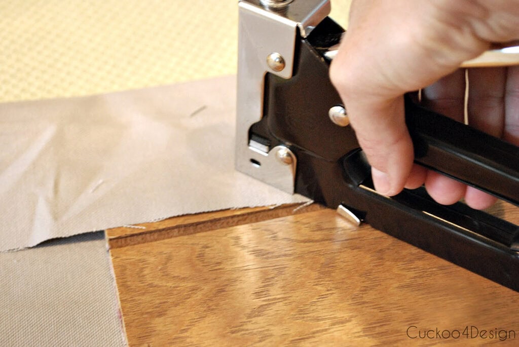 using a staple gun to attach fabric