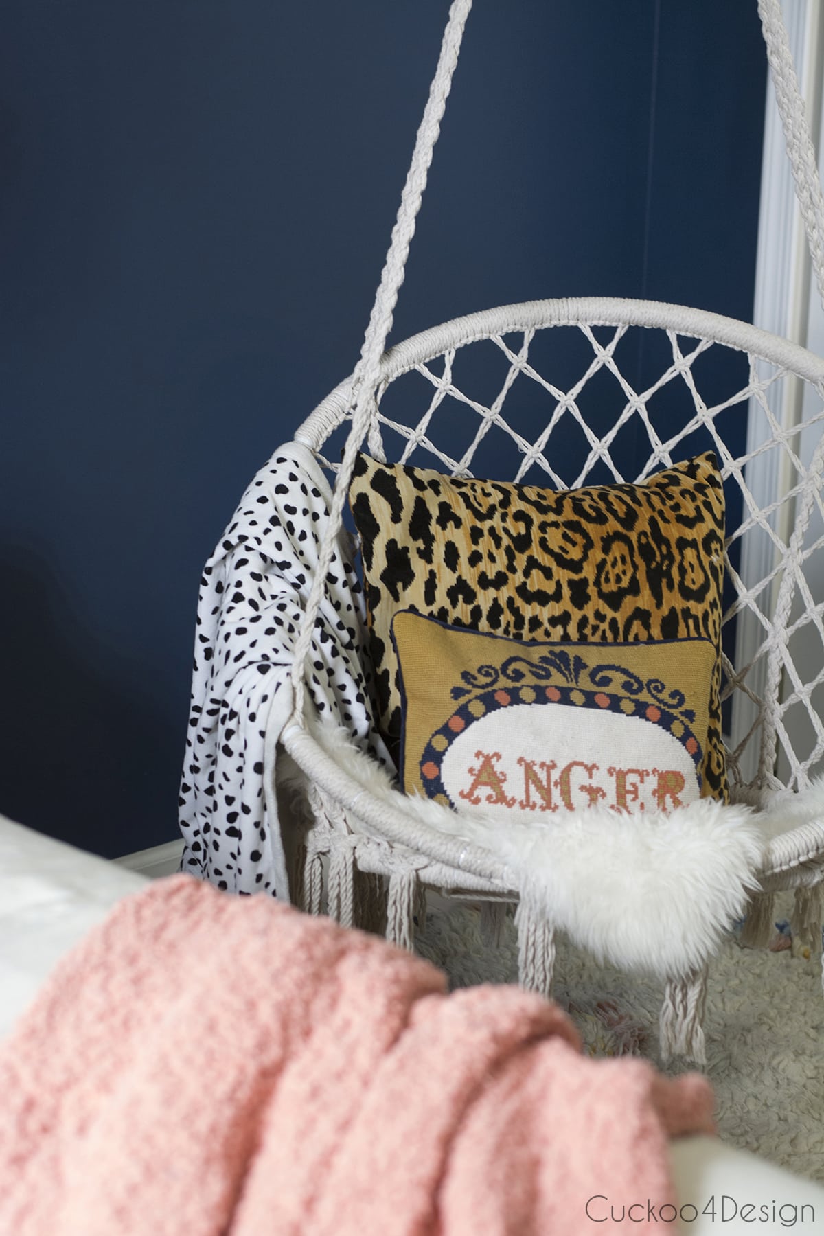 macrame hanging chair with leopard throw pillow