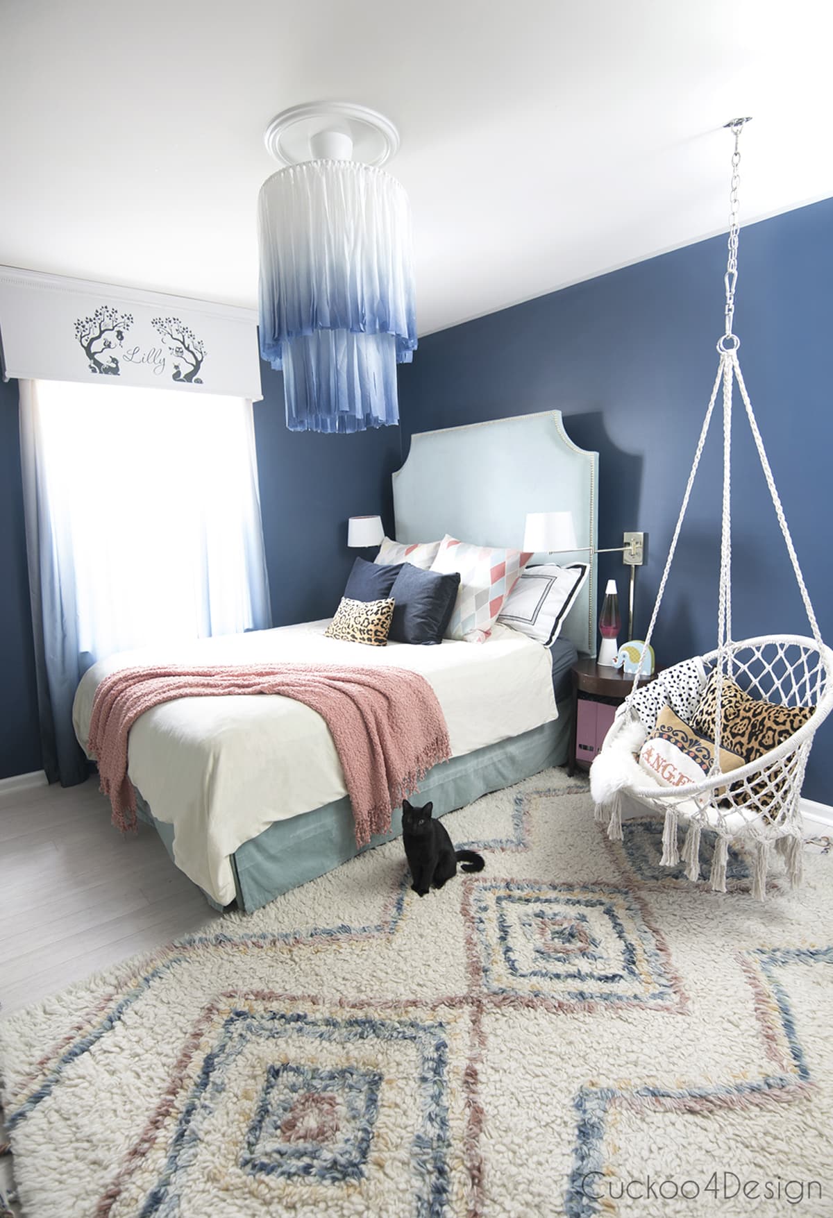 white and blue chandelier in dark blue bedroom