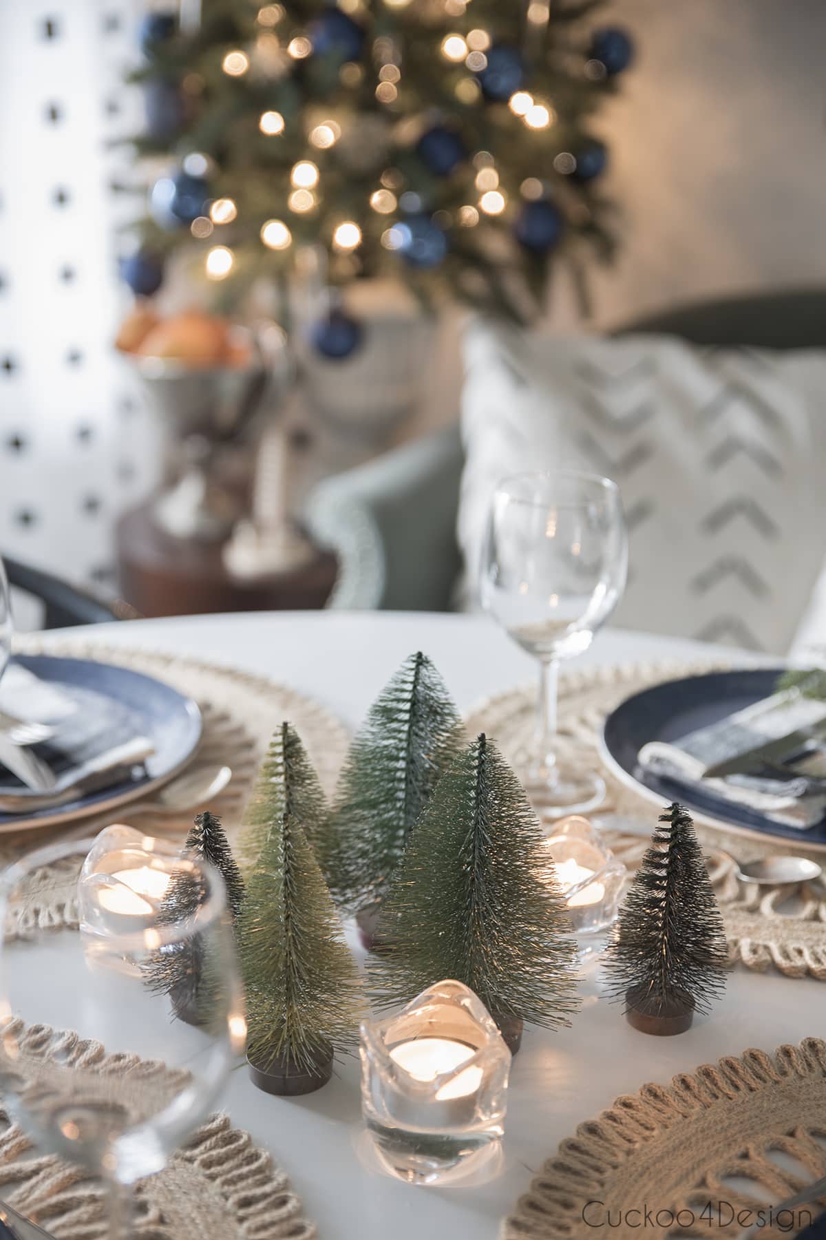 bottle brush trees on dining table with candles