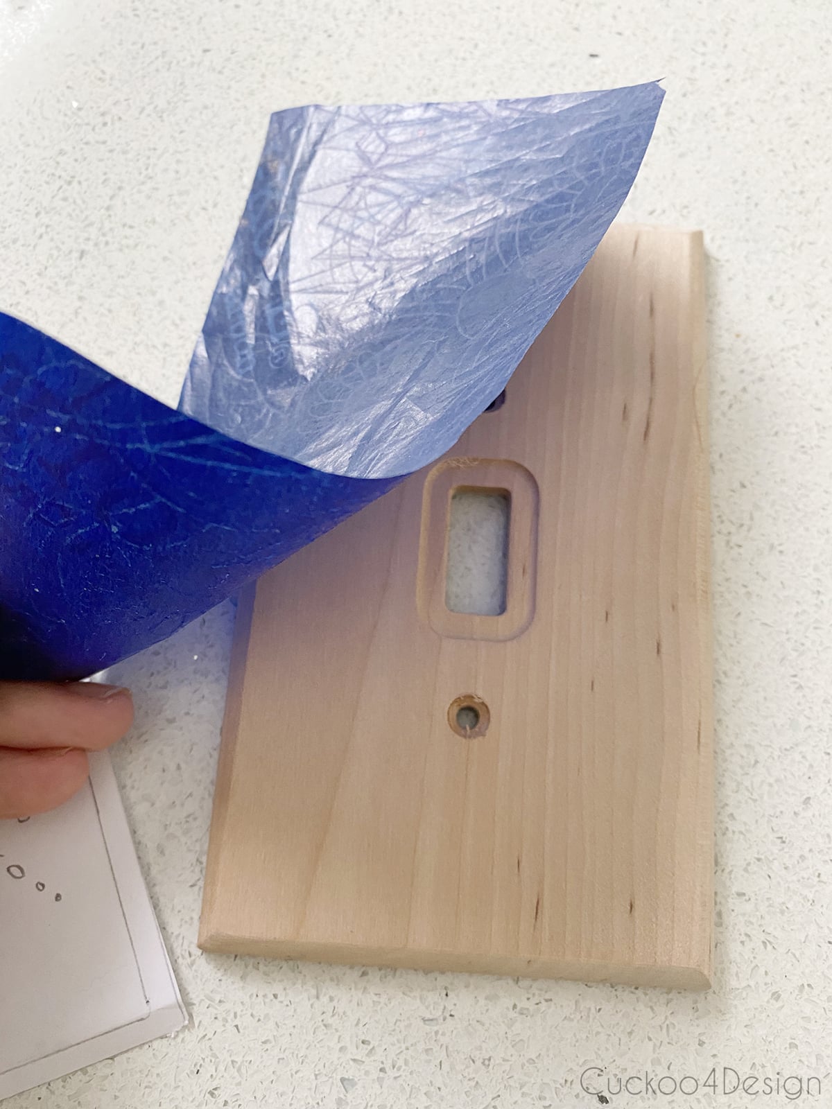 taping carbon transfer paper to the wooden light switch cover