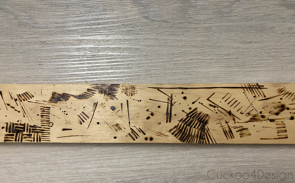 practicing wood burning on a piece of scrap wood