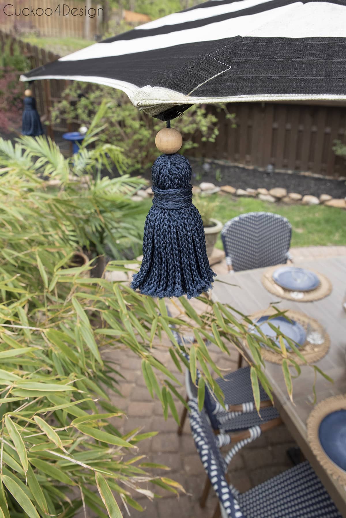 sideview of the tassel umbrella with cat enclosure in the background 