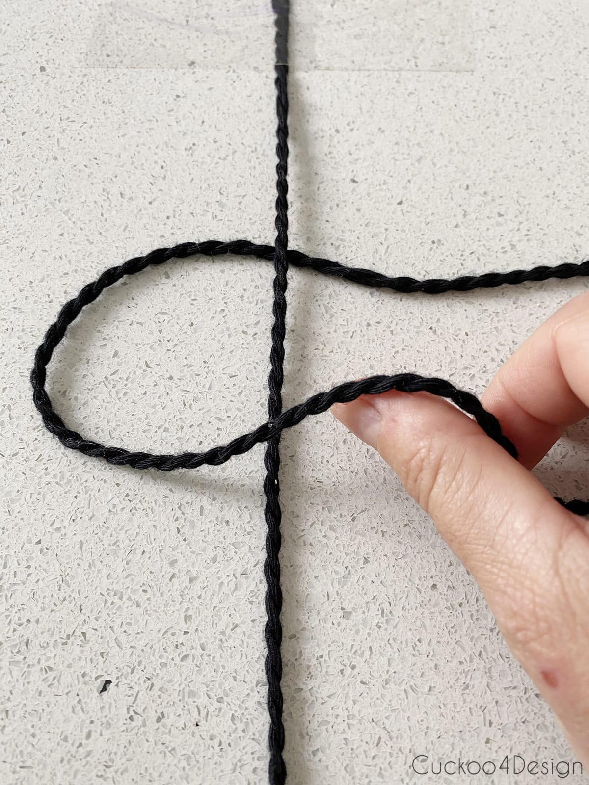 folding the left string over the center string