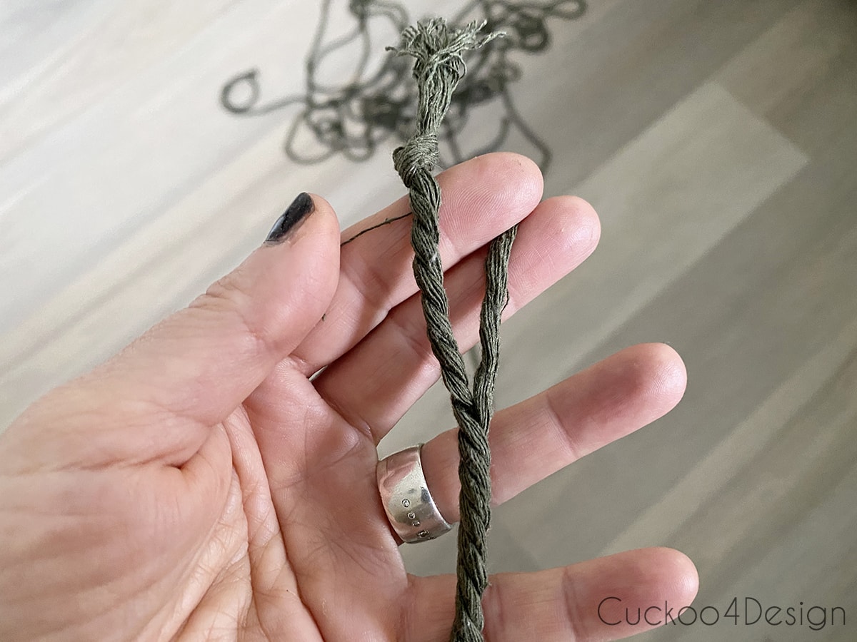 unraveling strands of dark green macrame yarn