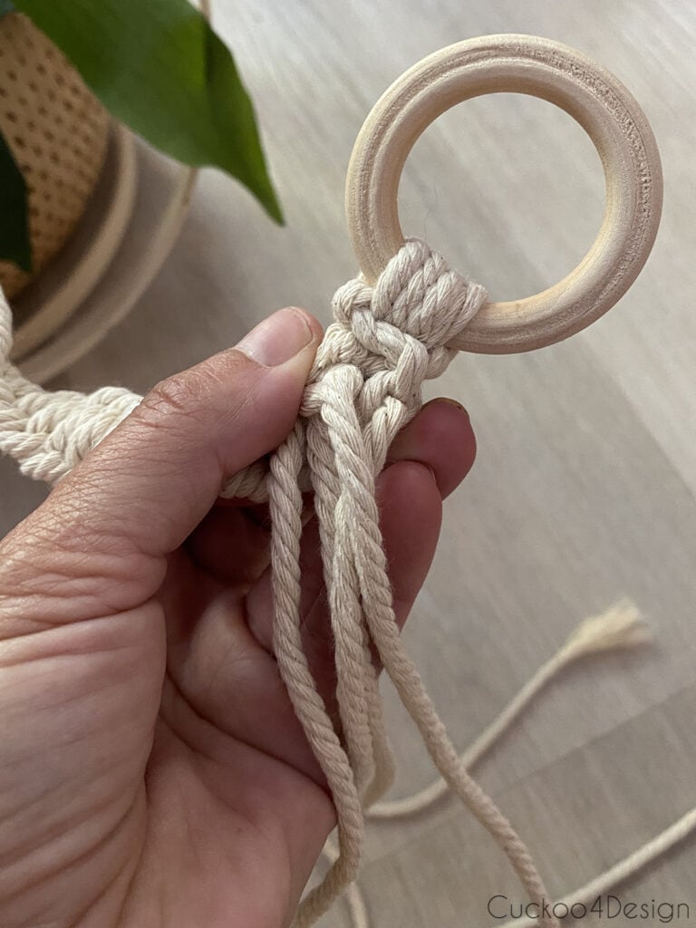 strands knotted to the wooden ring