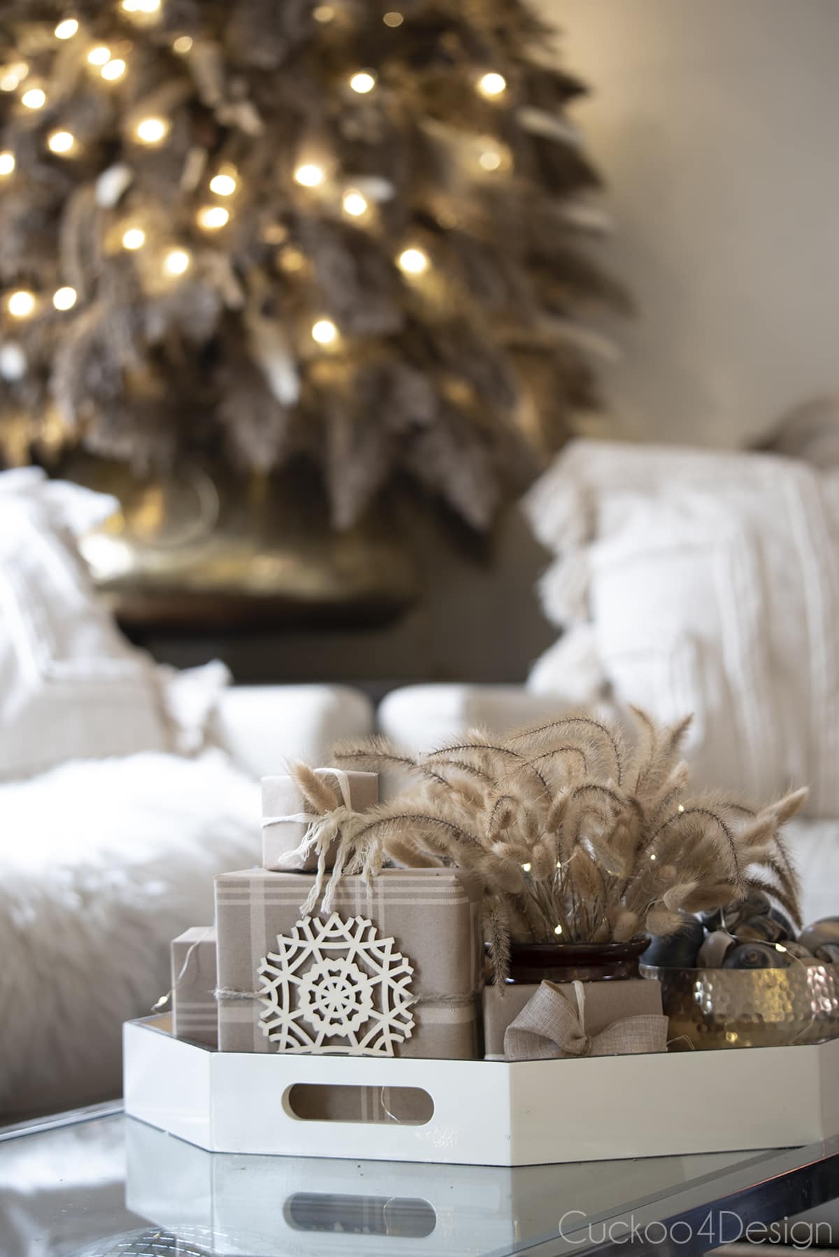 close-up of dried floral Christmas tree and boho coffee table decor with presents