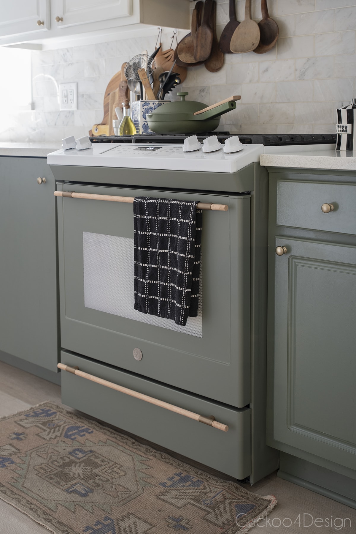 custom stove in dark sage green to match cabinets