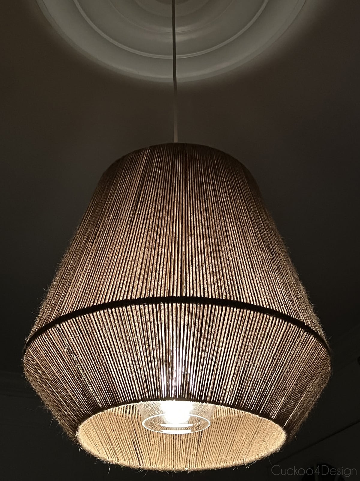 jute pendant light with lights on in complete darkness