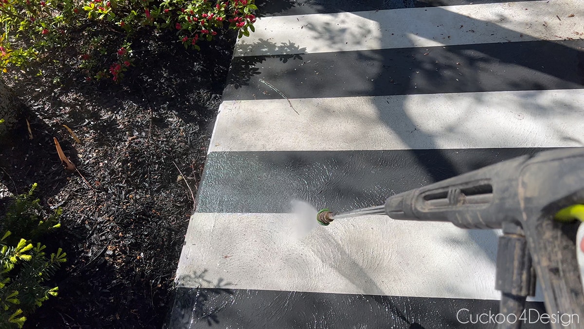 pressure washing the painted concrete patio