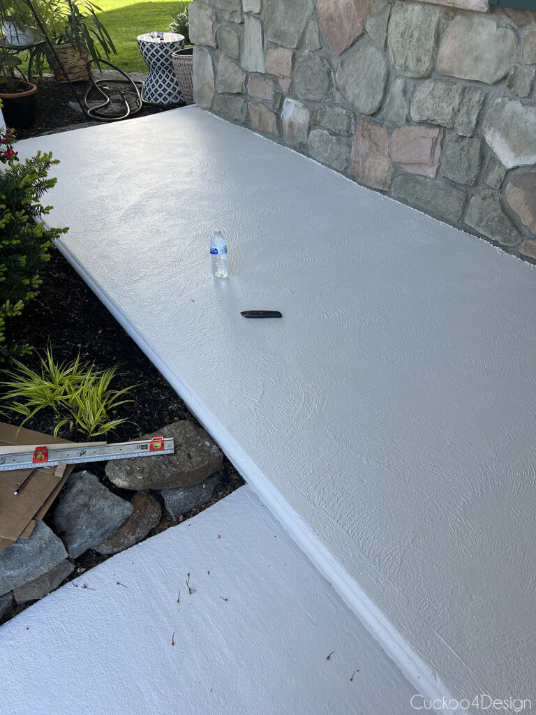 two coats of white concrete floor paint on porch