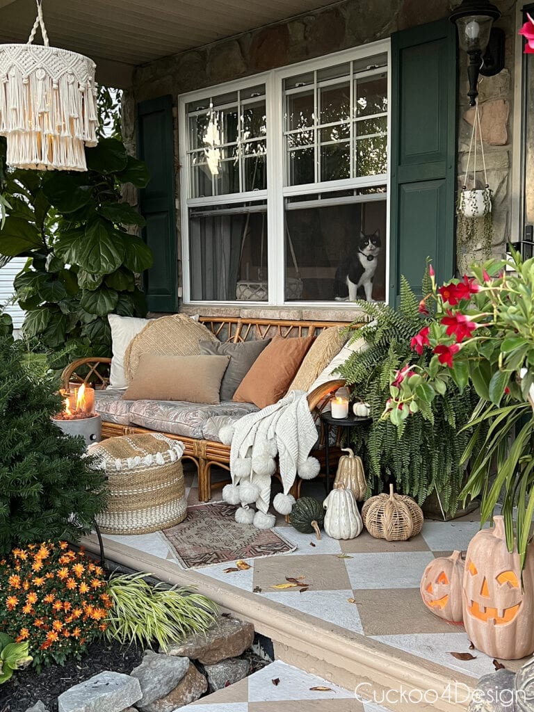 cozy fall porch with dark green and terracotta accents and macrame chandelier