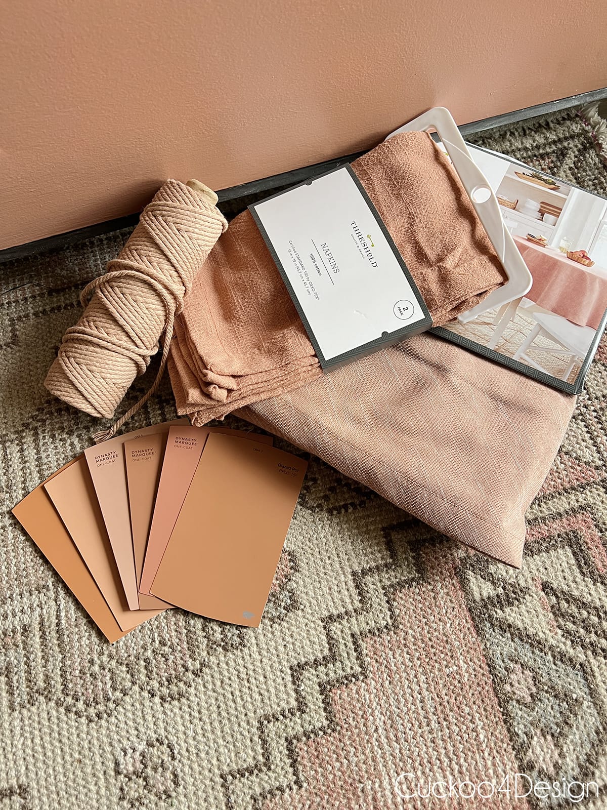 different home decor accessories and paint samples in pretty shades of terracotta paint colors