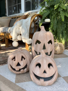 group of three finished terracotta pumpkin jack lanterns