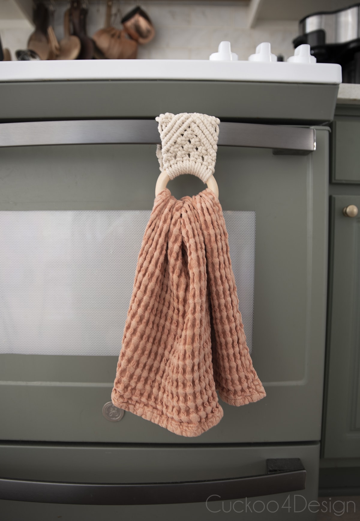 close-up of macrame towel holder on stove handle