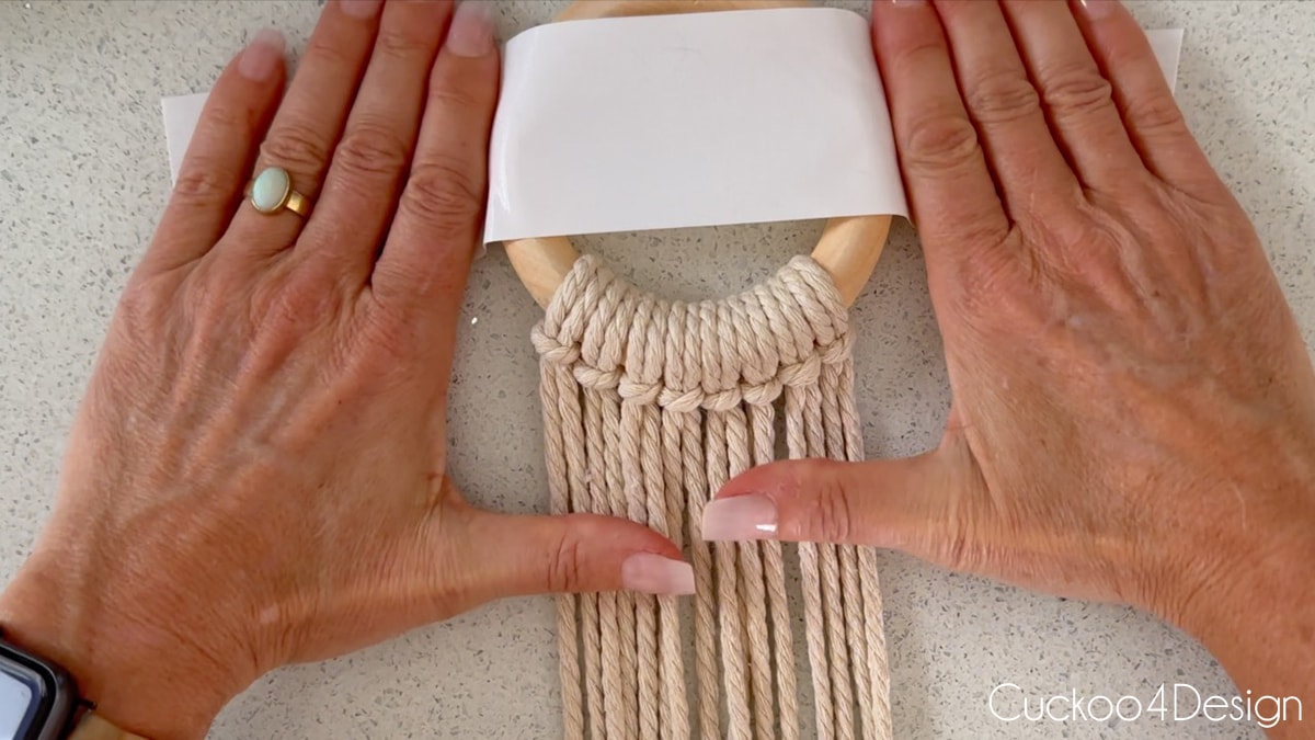 tape macrame ring with yarn to flat surface