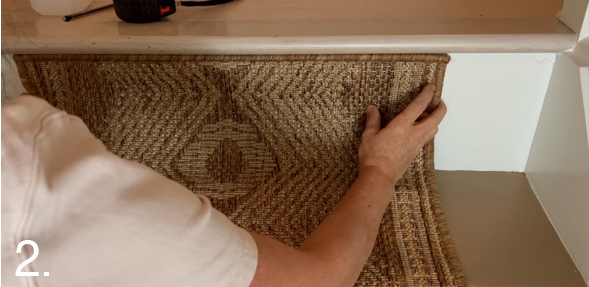 Align the rug at the top of the stairs