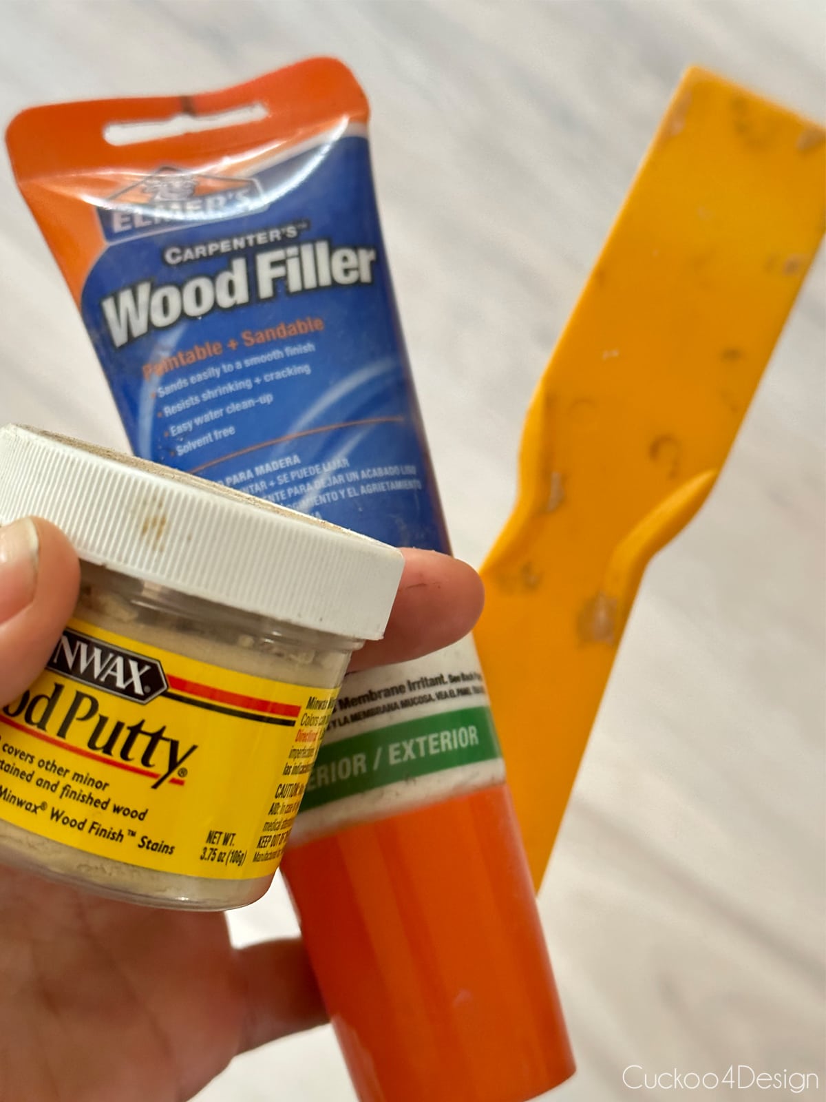 patching holes with wood putty and putty knife