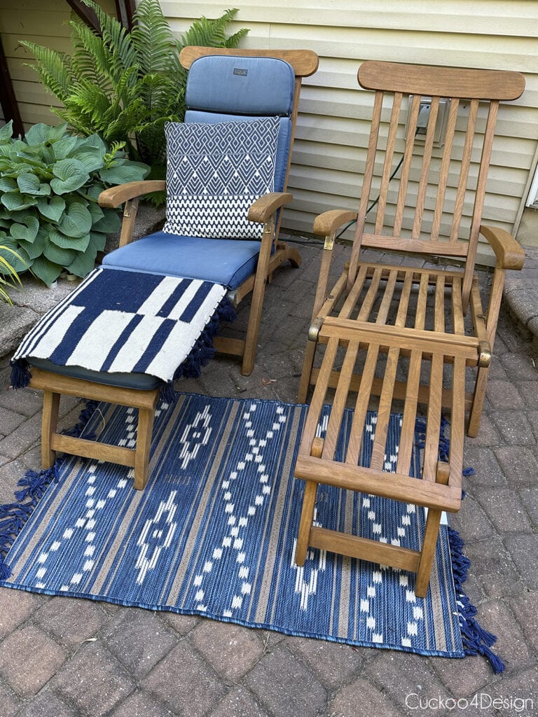 finished restored teak outdoor chair with cushions next to finished teak outdoor chair without cushions