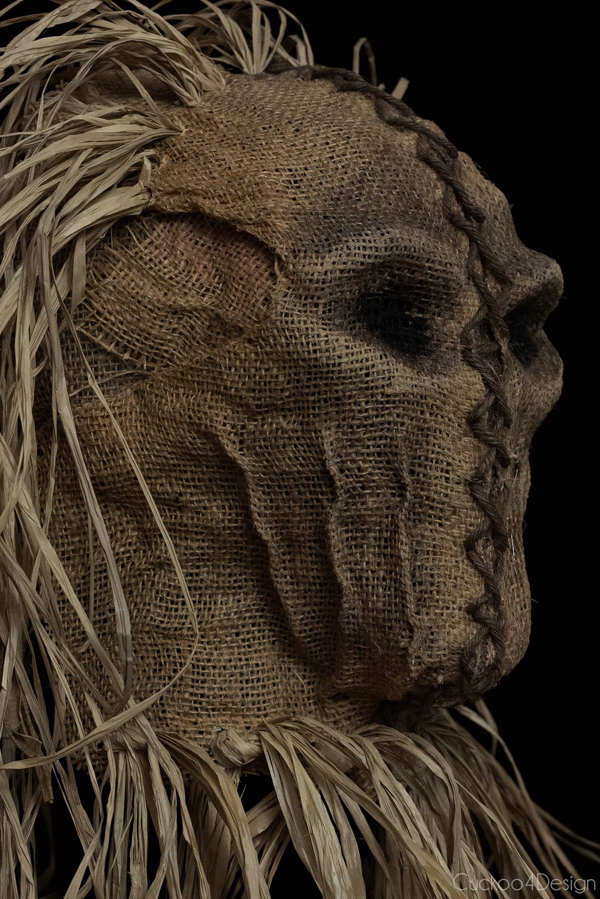 close-up of left side view of finished scary scarecrow mask made with burlap and raffia