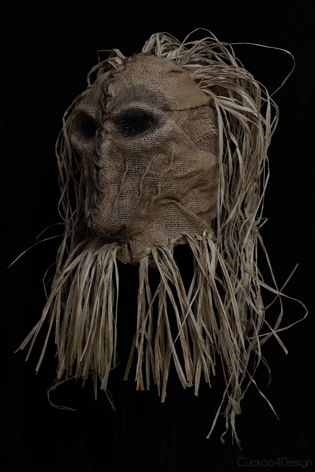 right side view of finished scary scarecrow mask made with burlap and raffia